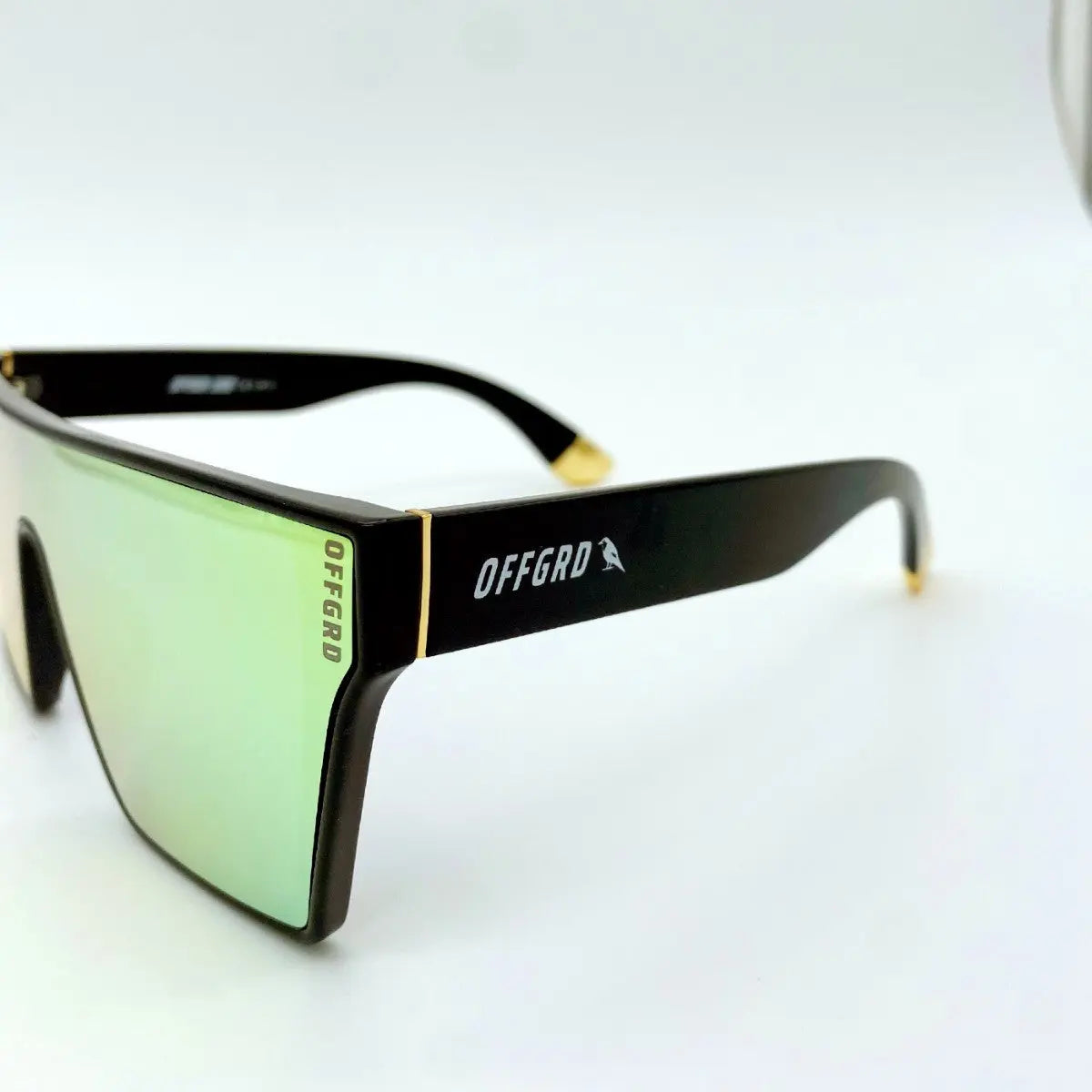 Sunglasses with black frame and gold lenses on a white background